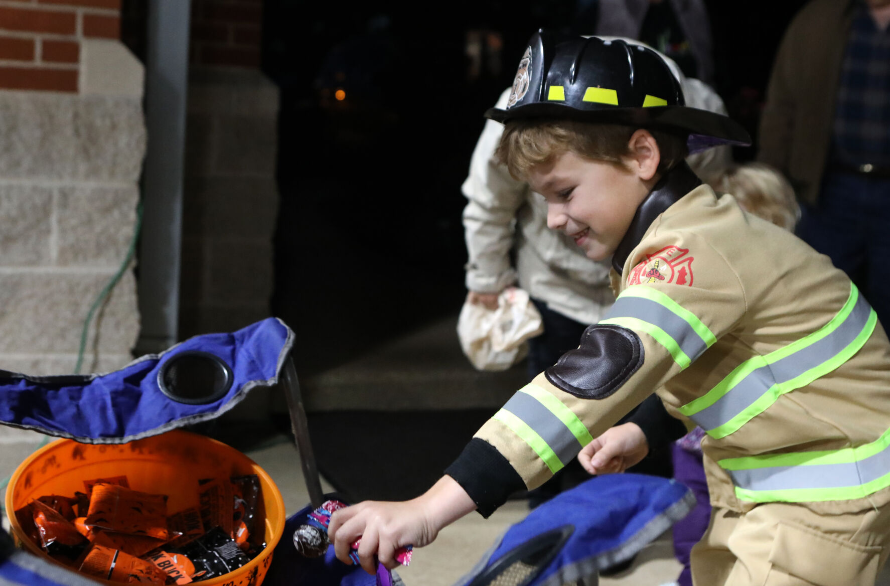 Brayden Ftacek reaches for candy